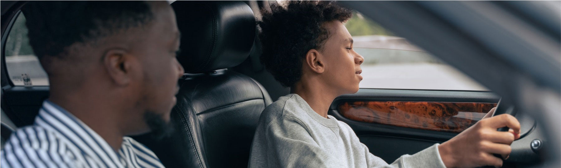 father teaching son how to drive